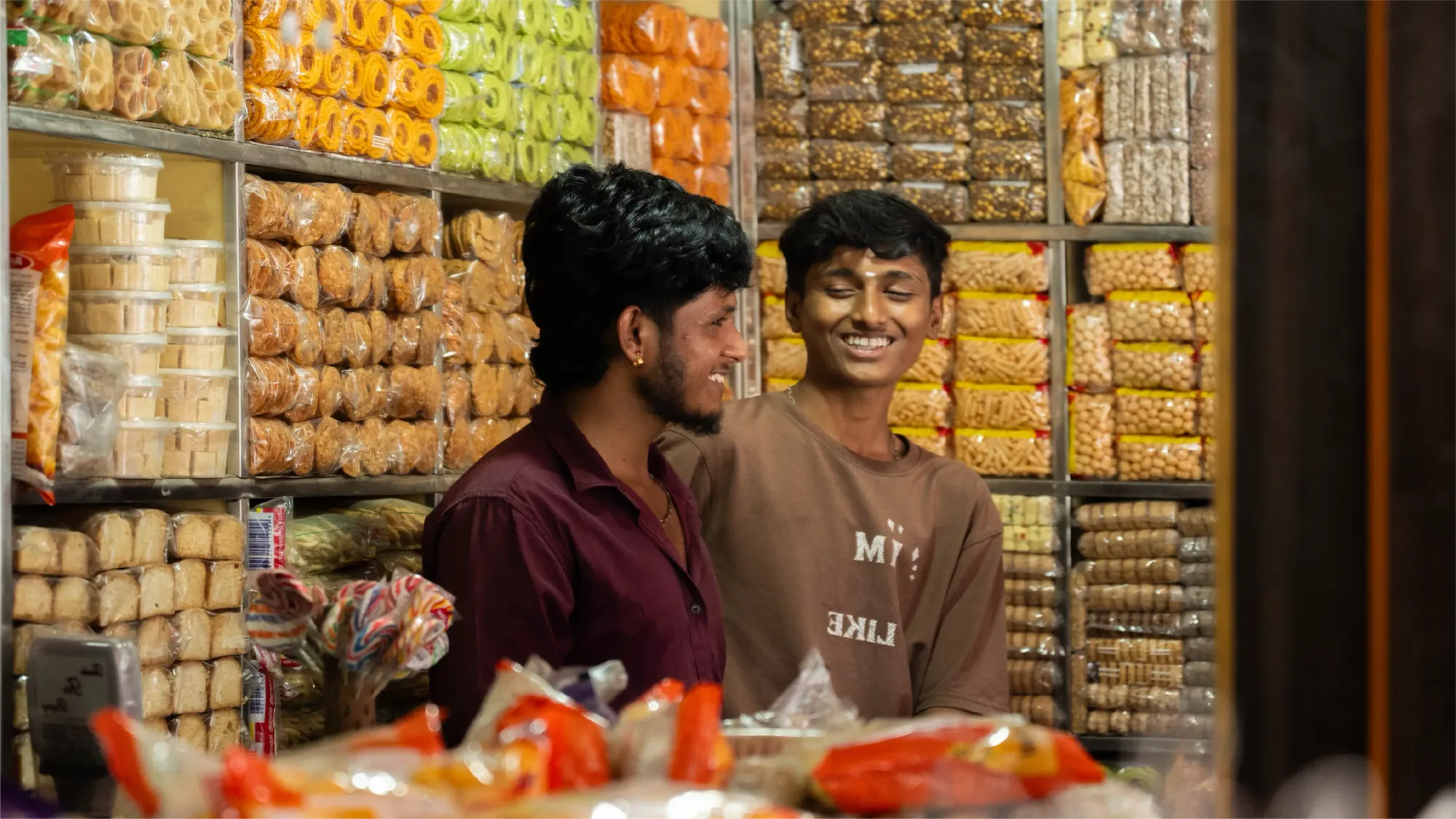 Surrounded by sweets and savouries in their shop, the brothers share a joke and have a laugh