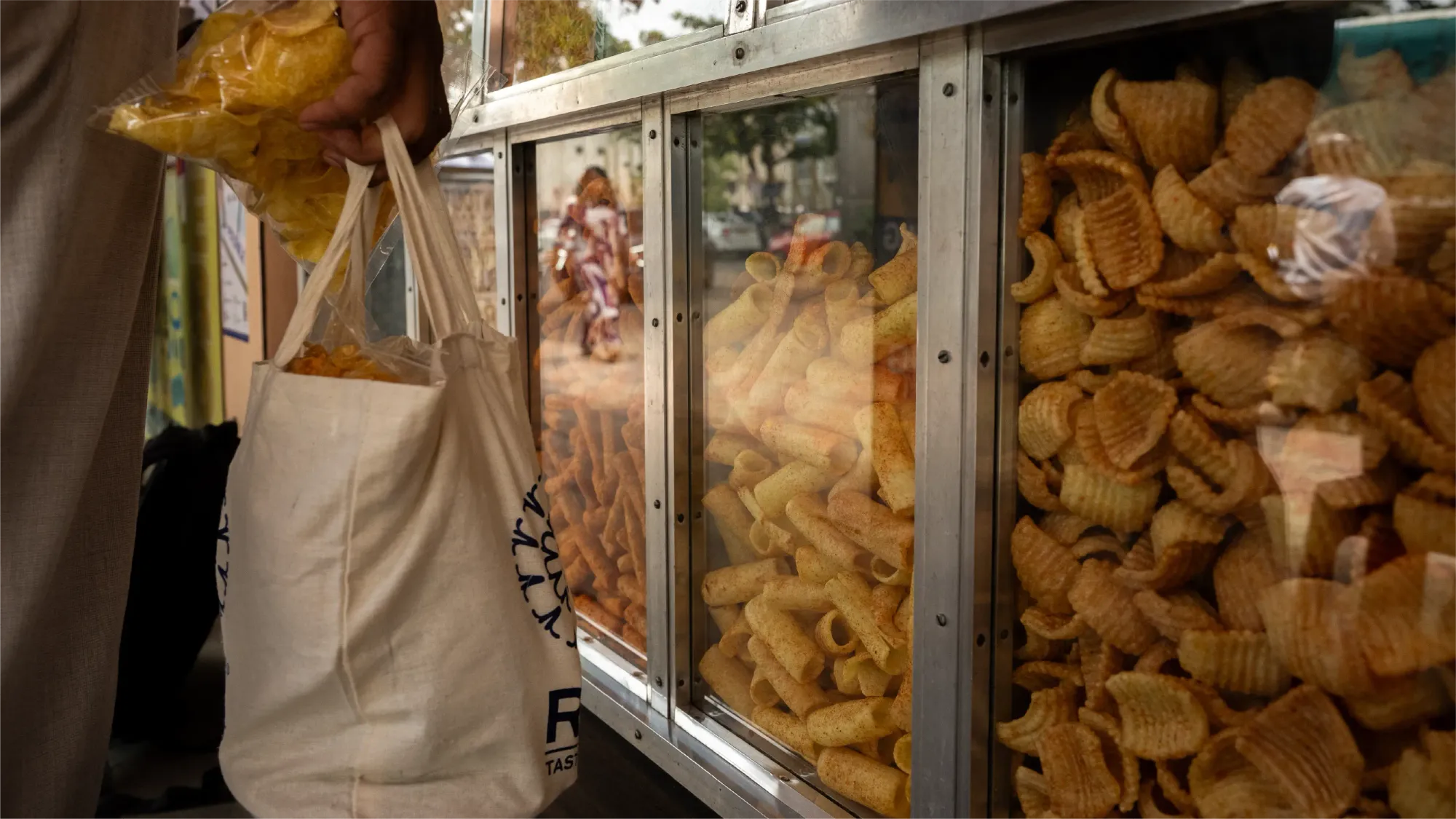 A classic glass display filled with different types of local snacks made by Sri Ganapathi Hot Chips