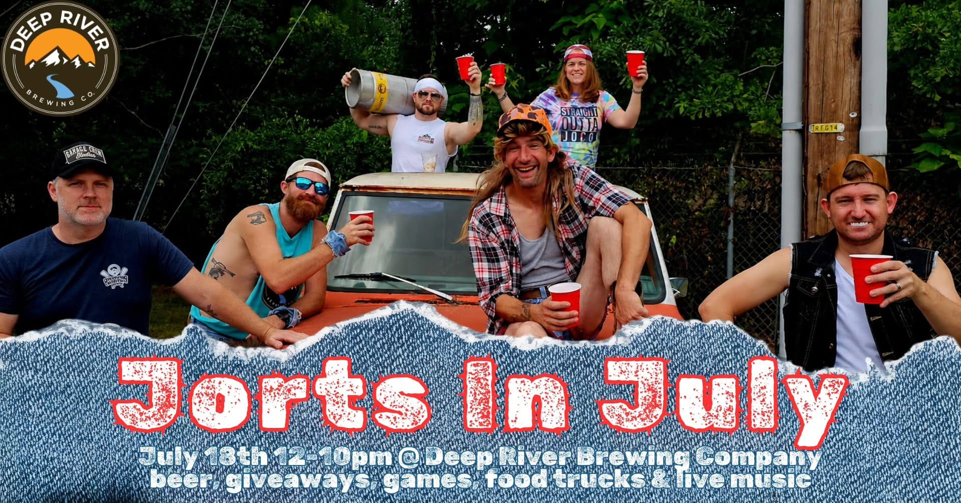 Promotional image for Jorts in July showing six adults in cutoff denim, trucker hats and mullet wigs posing with red cups and a beer keg around an old pickup truck.