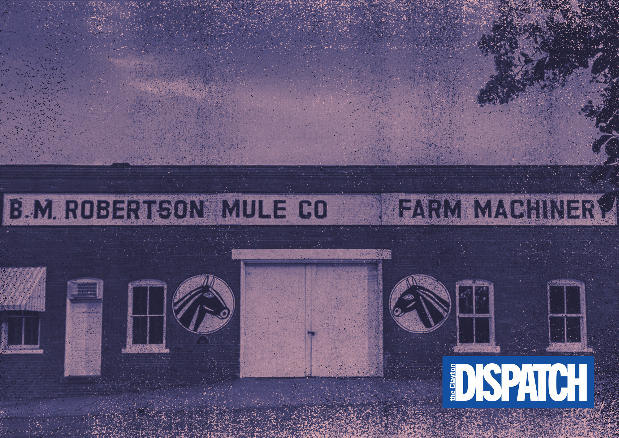 Historic B.M. Robertson Mule Company building in Downtown Clayton, with the original “B.M. Robertson Mule Co. Farm Machinery” signage and mule emblems visible across the brick facade. The image is tinted purple with The Clayton Dispatch logo in the lower right corner.