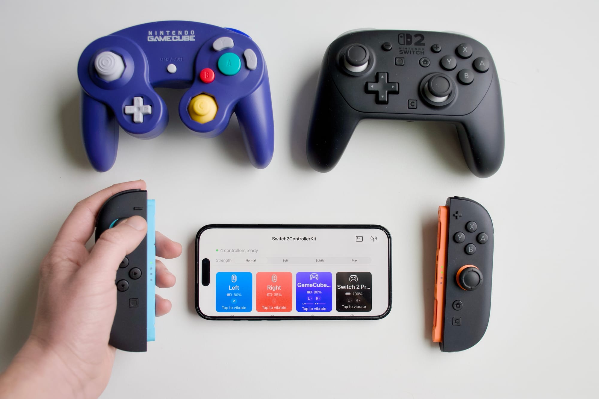 Our testing app on iPhone, connected to the Joy-Con 2 controllers, Pro Controller and GameCube Controller.