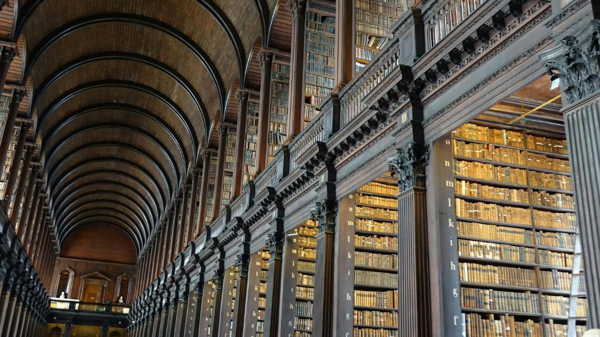 Interior of a historic library with towering bookshelves.