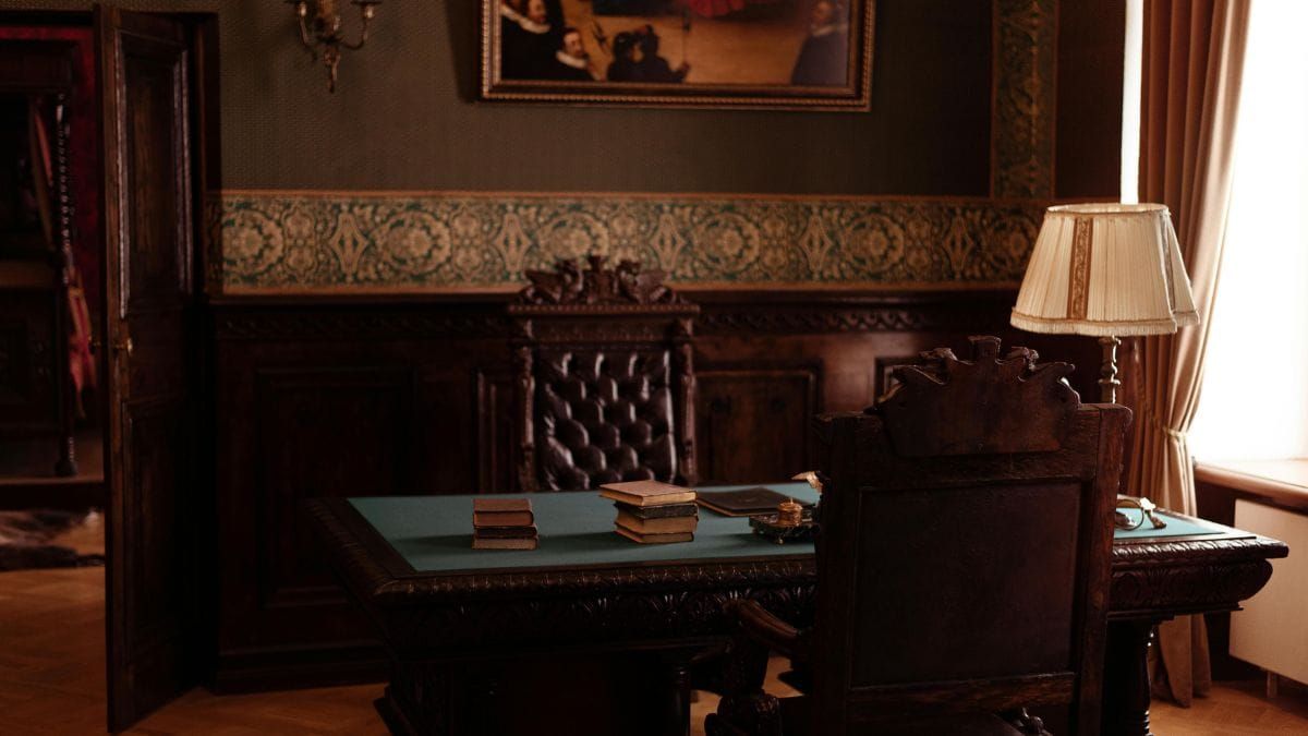 Vintage library desk with books in a warmly lit old study