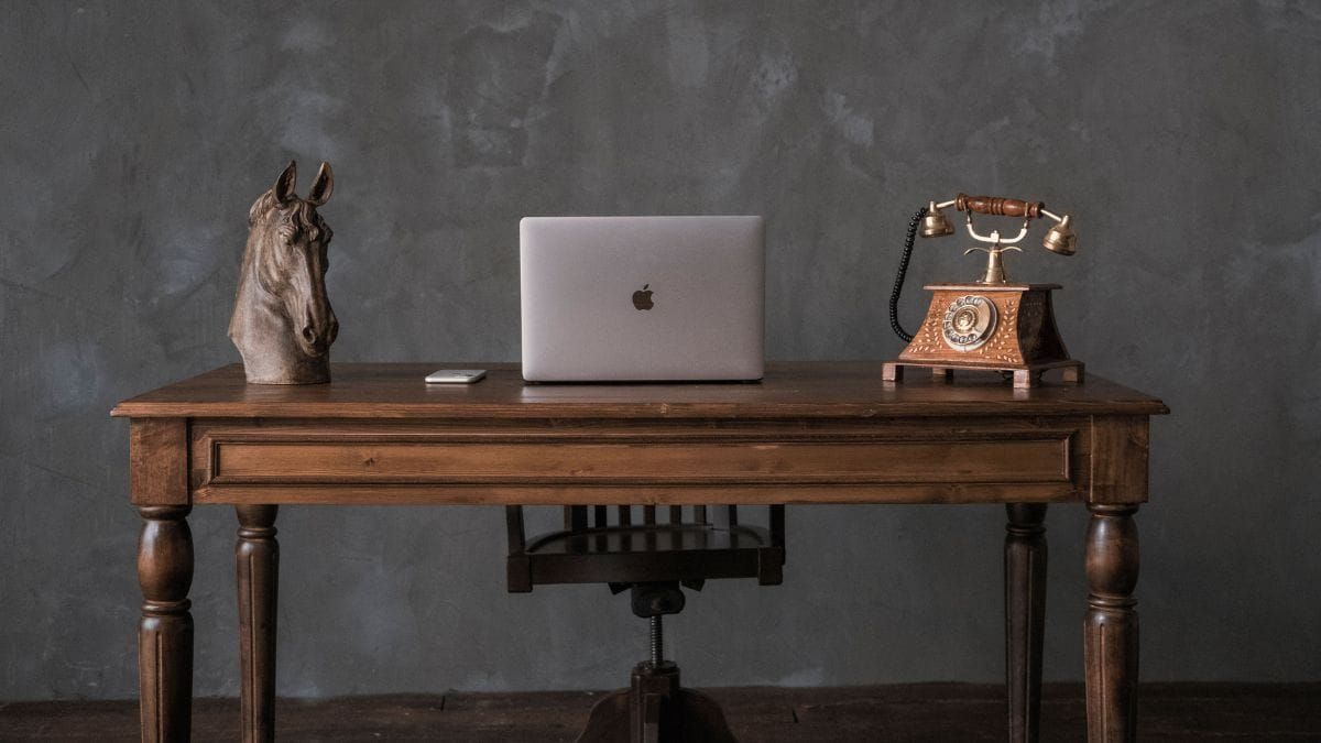 A quiet writing desk with a laptop and vintage objects