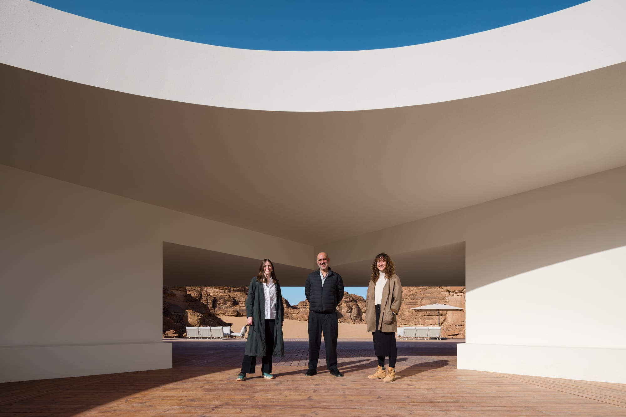 The architects of this year's Desert X visitor center framed by the building