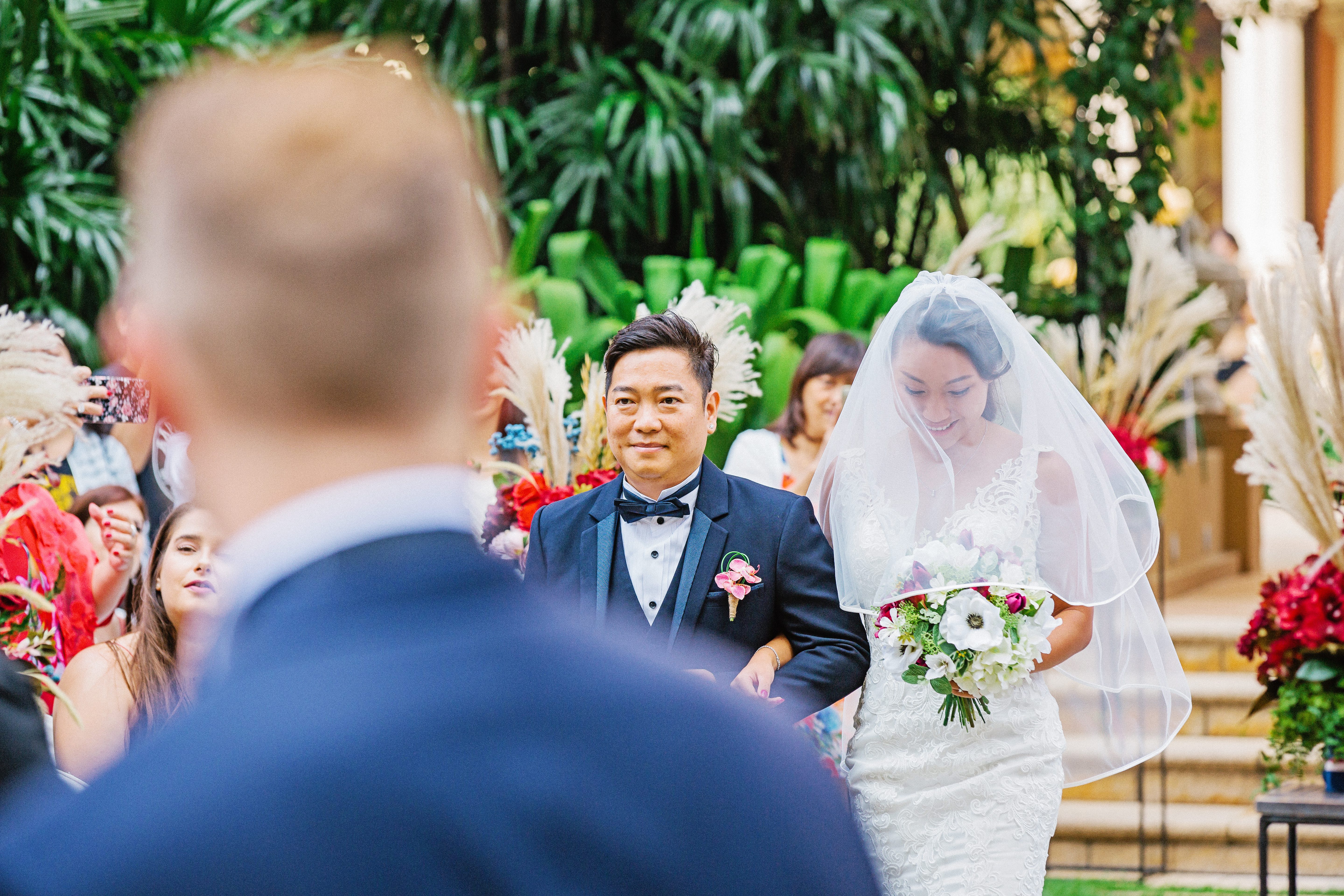 Switching to a telephoto lens for a tighter picture with focus on the expressions of the bride and her father.