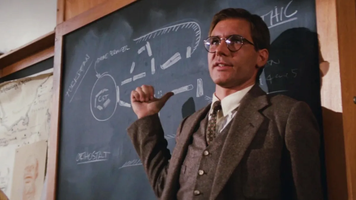image of Indiana jones in front of a chalkboard teaching