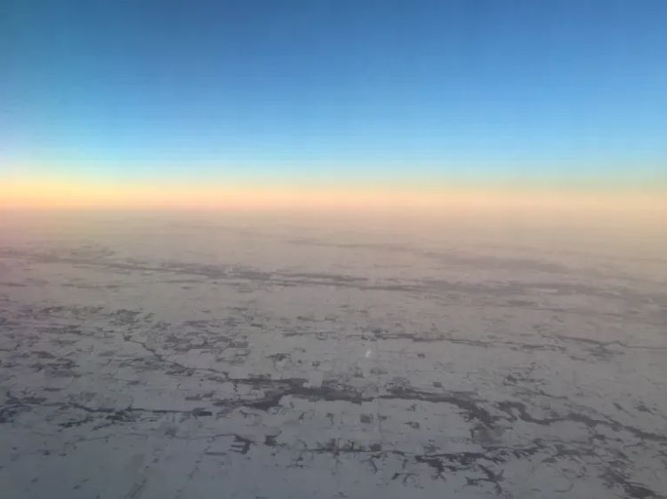 image from a plane window of a snowy landscape. probably over Iowa. photo by mcglynn