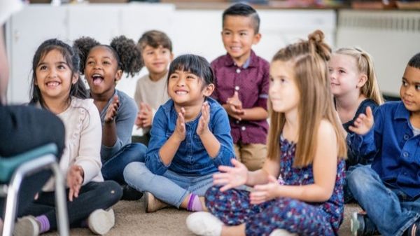 Group of children smiling and clapping