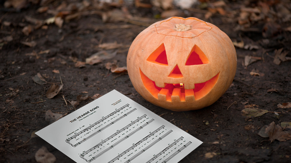 "The Hearse Song" sheet music next to carved pumpkin