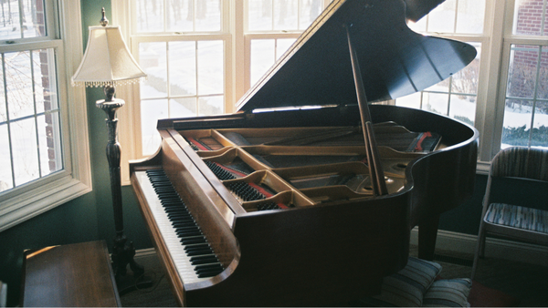 piano by window, snow outside