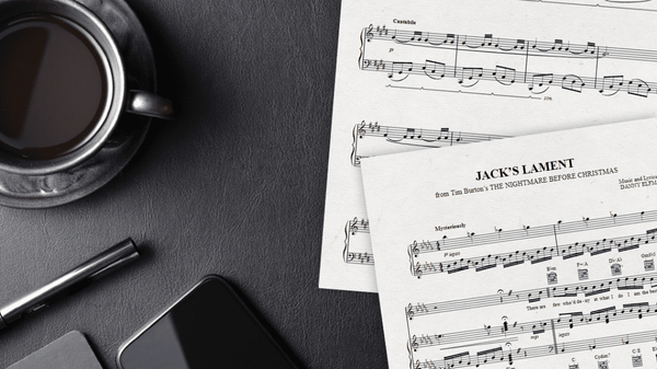 Sheet Music of Jack's Lament surrounded by black objects on a black background.