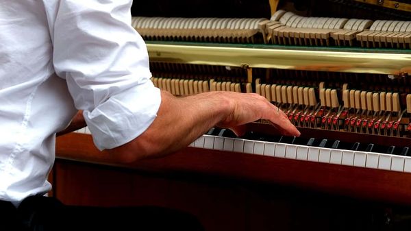 image: playing piano; article: piano posture: stay injury free with these tips