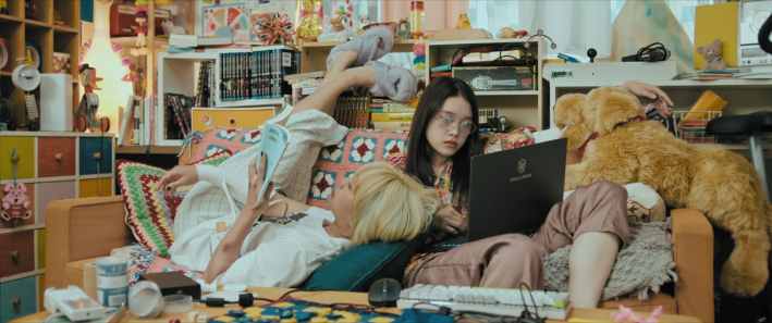 Mahiro and Chisato lazing about on their couch in Baby Assassins: 2 Babies.