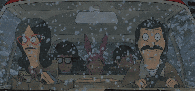 A gif from the cartoon "Bob's Burgers:" the Belcher family rides in a car, as seen through the front windshield. Snow falls on the windshield.