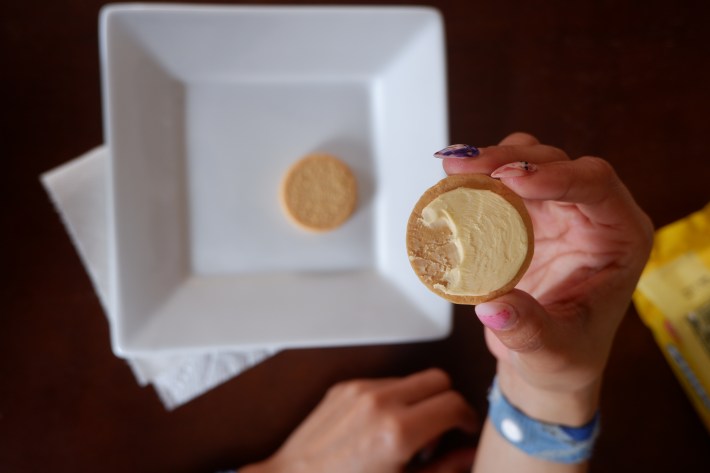 A bitemark on the creme part of a split Oreo cookie. 