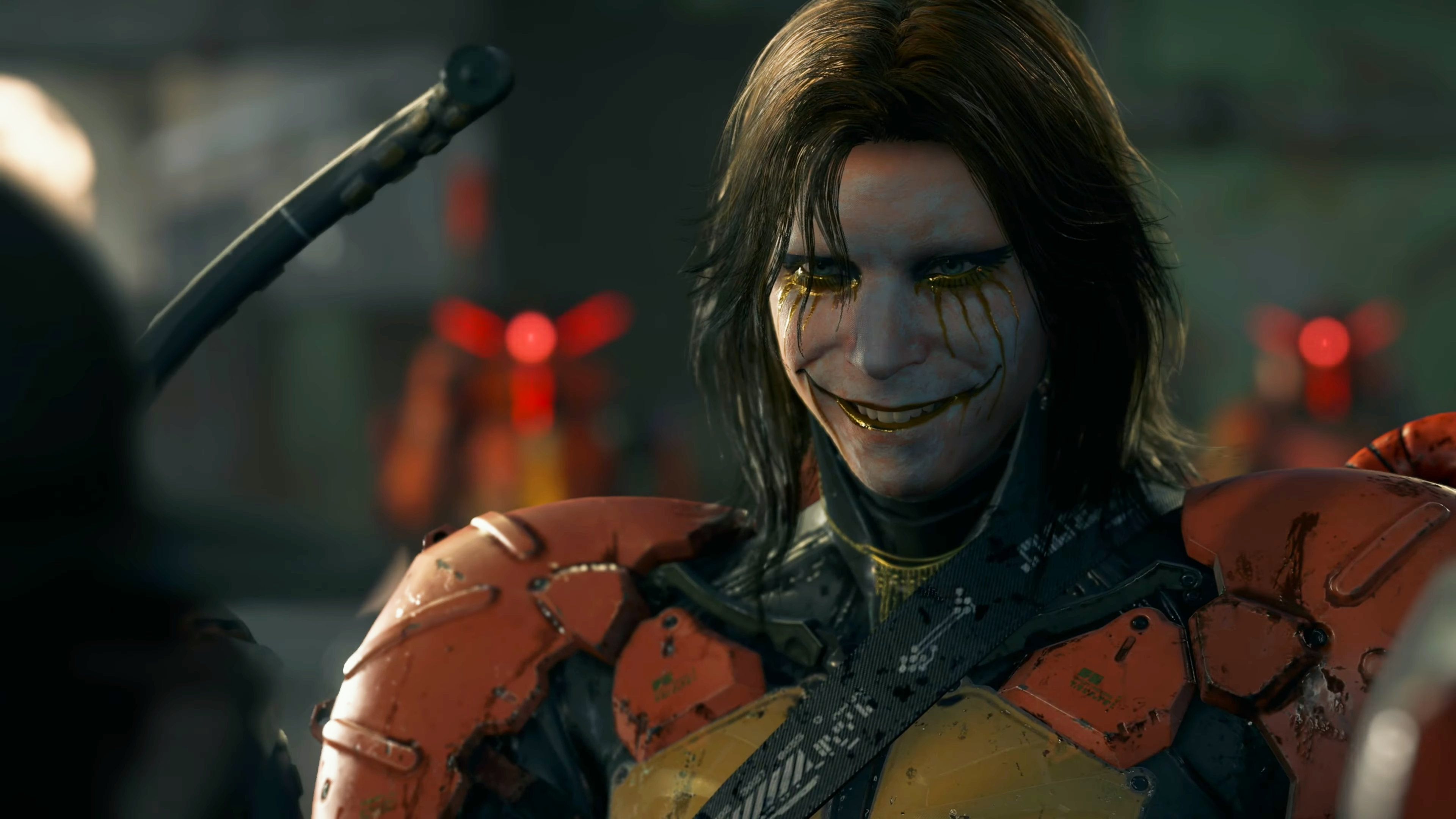 Higgs in Death Stranding played by Troy Baker, smiling. He is a cyborg wearing clown makeup and eyeliner.