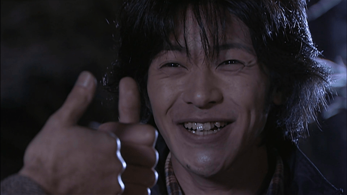 Kamen Rider Kuuga's Yusuke giving a thumbs up. 