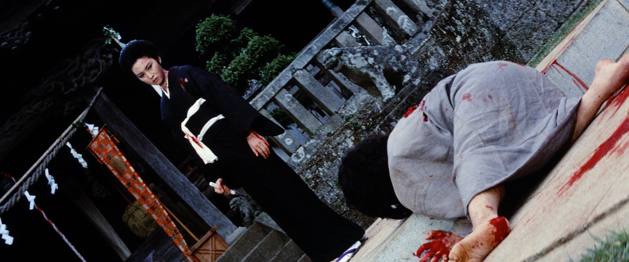 Lady Snowblood still of Meiko walking down her adversary. 