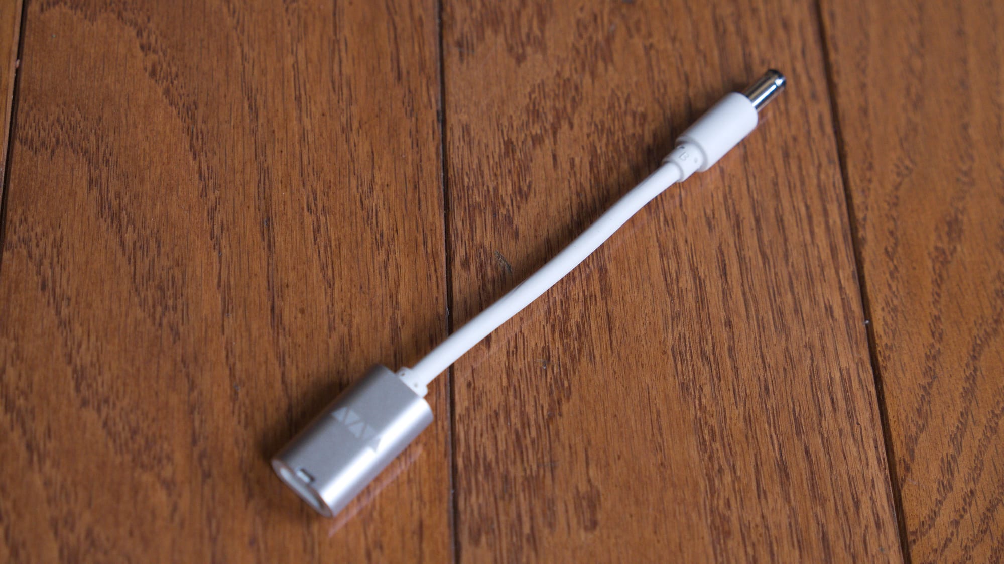 A VFLEX with attachment. It is a metal dongle with a wire connecting to a barrel jack.