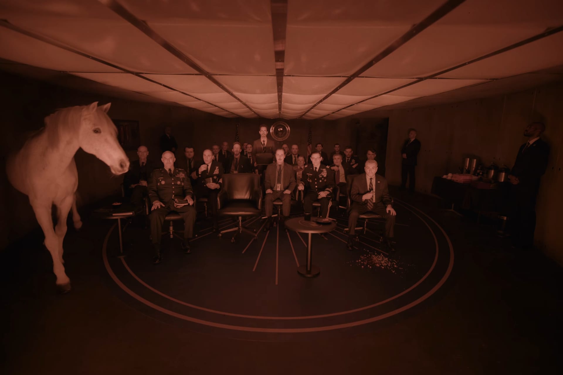 Digger still of army generals in a war room with a horse.