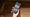 A hand holding a phone that's displaying the Roblox app
