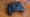 A controller sits on a wood backdrop, it has two huge game pads on it. 