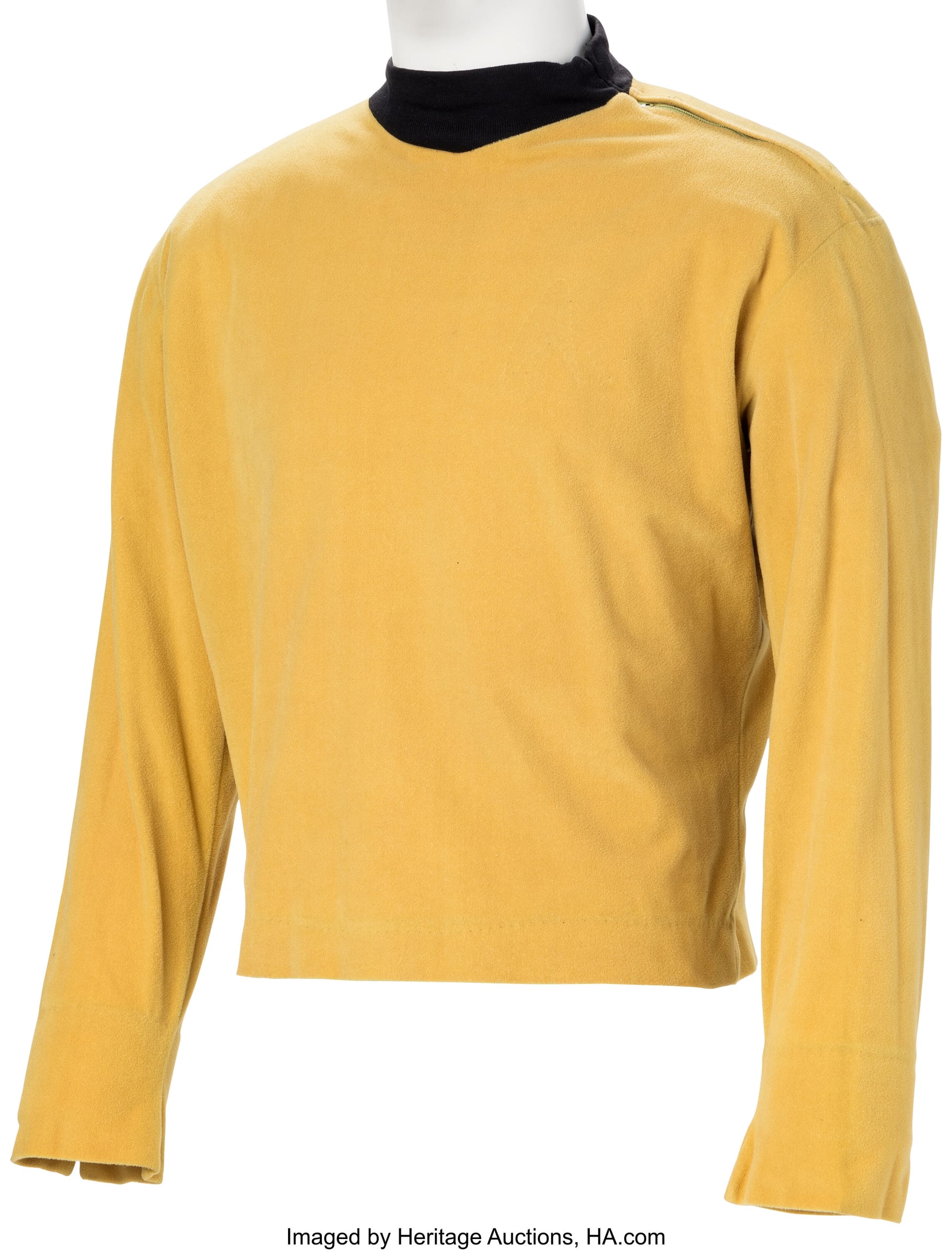 A mustard velour tunic with black collar. A zipper runs down the neck to the shoulder. Notch slits are at the cuff. 