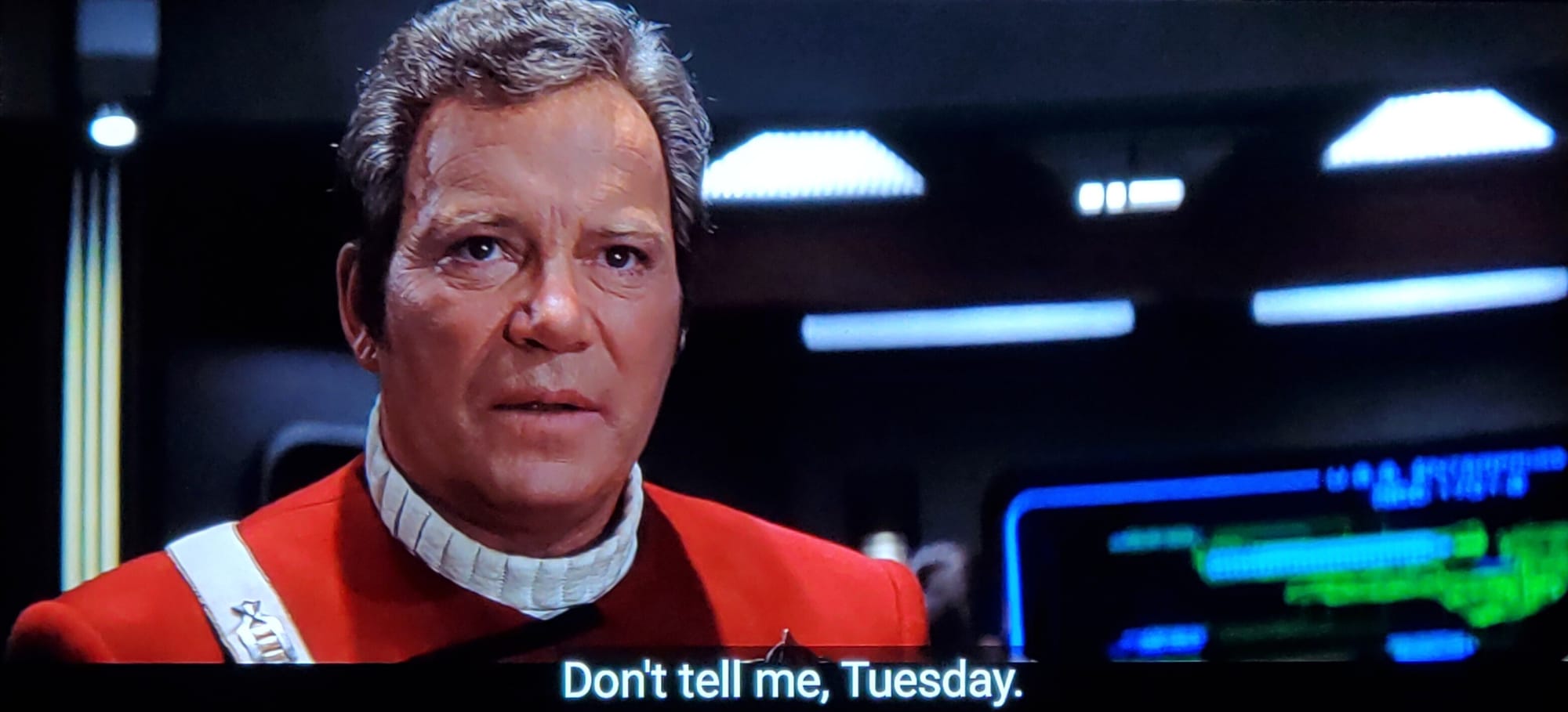 William Shatner as Captain James T. Kirk in STAR TREK: GENERATIONS on the bridge of the USS ENTERPRISE-B. Closed caption text reads: "Don't tell me, Tuesday".
