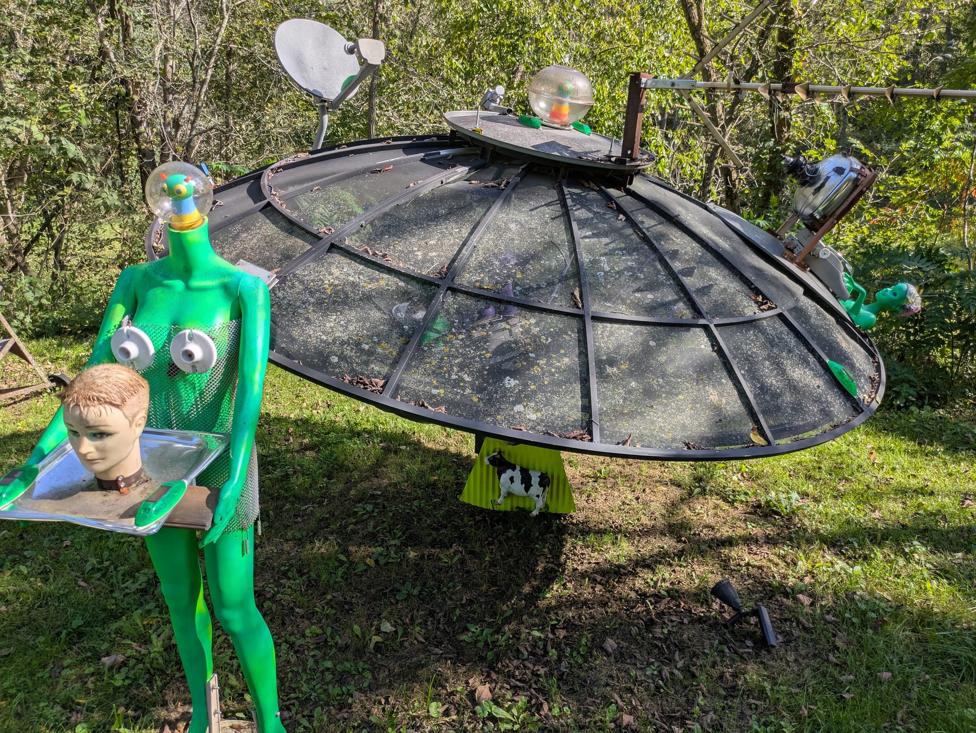 Satellite dish UFO with a smaller Satellite Dish mounted on it, with green aliens, oh, and it's beaming up a cow
