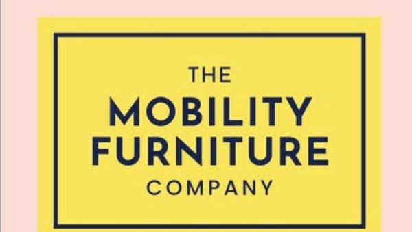 A yellow sign on a pink background with the words Mobility Furniture Company