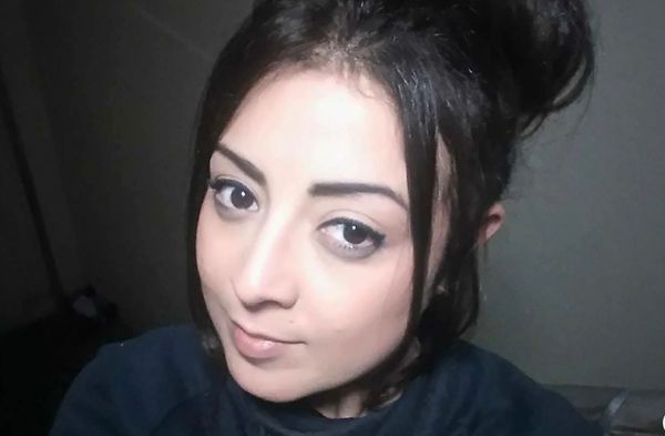 A picture of a woman Georgina Gharsellah dressed in dark clothing looking at the camera 