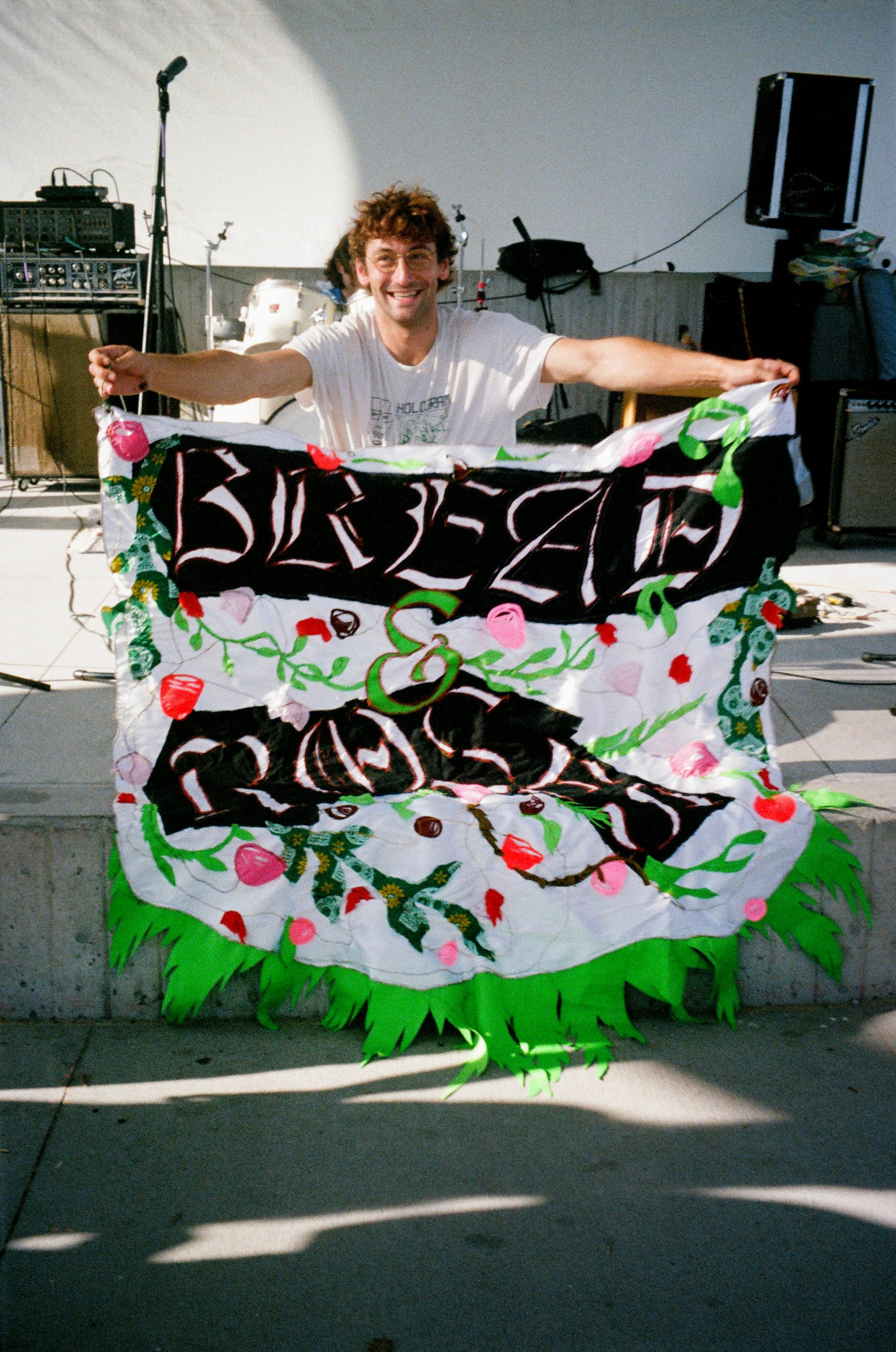 Jake Barczak of Bullseye poses with the festival banner, photo by Kate Vitali
