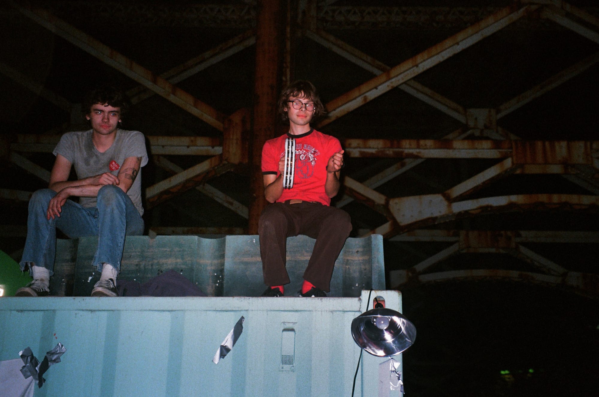Bread & Roses attendees on a shipping crate as bands perform directly below; photo by Kate Vitali