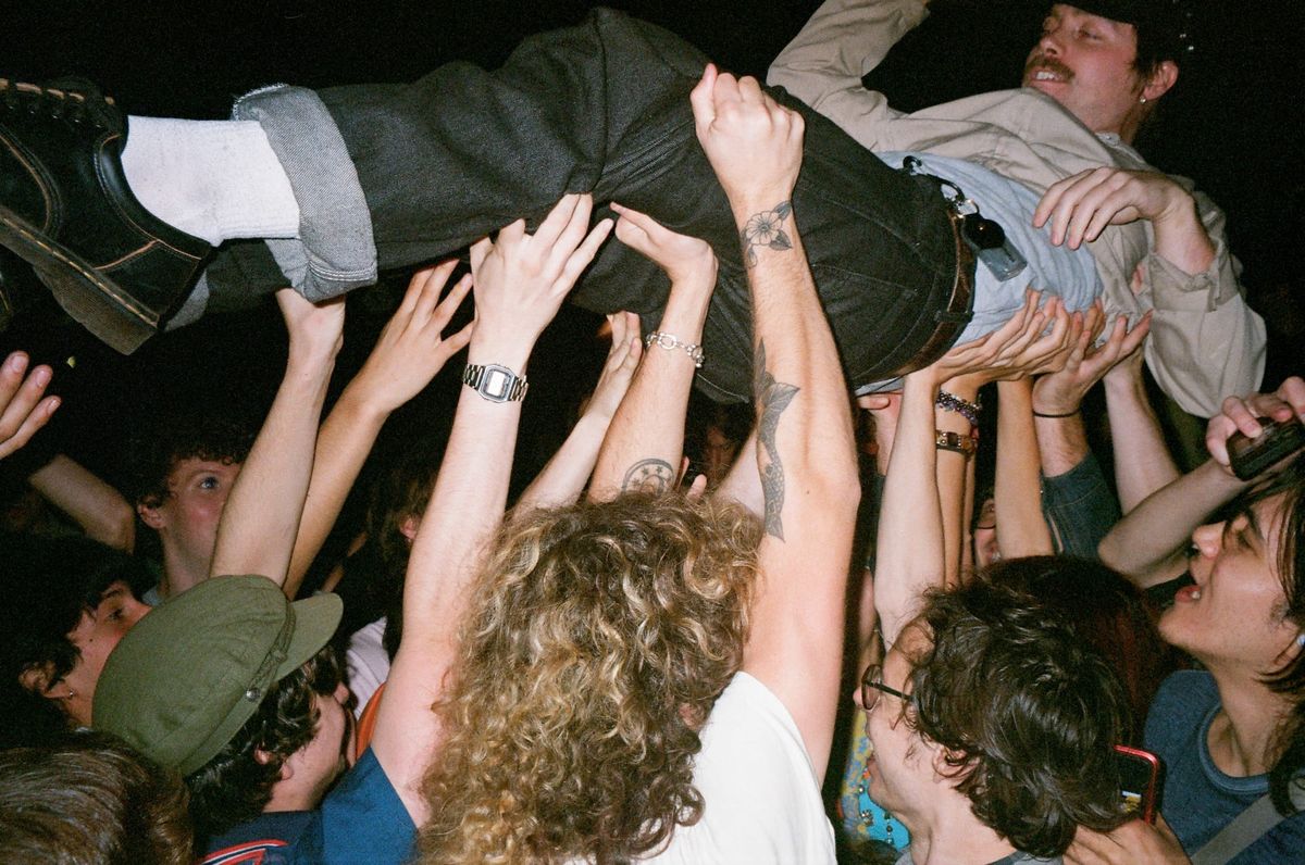 Luke Corvette of Good Flying Birds crowdsurfs at Bread & Roses 2025; all photos by Kate Vitali