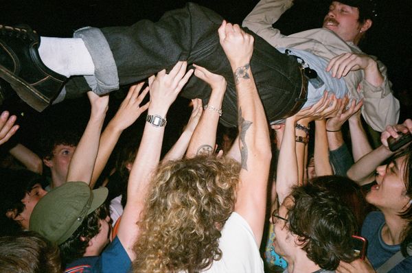 Luke Corvette of Good Flying Birds crowdsurfs at Bread & Roses 2025; all photos by Kate Vitali