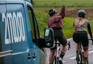 2moso van following two cyclists on the road