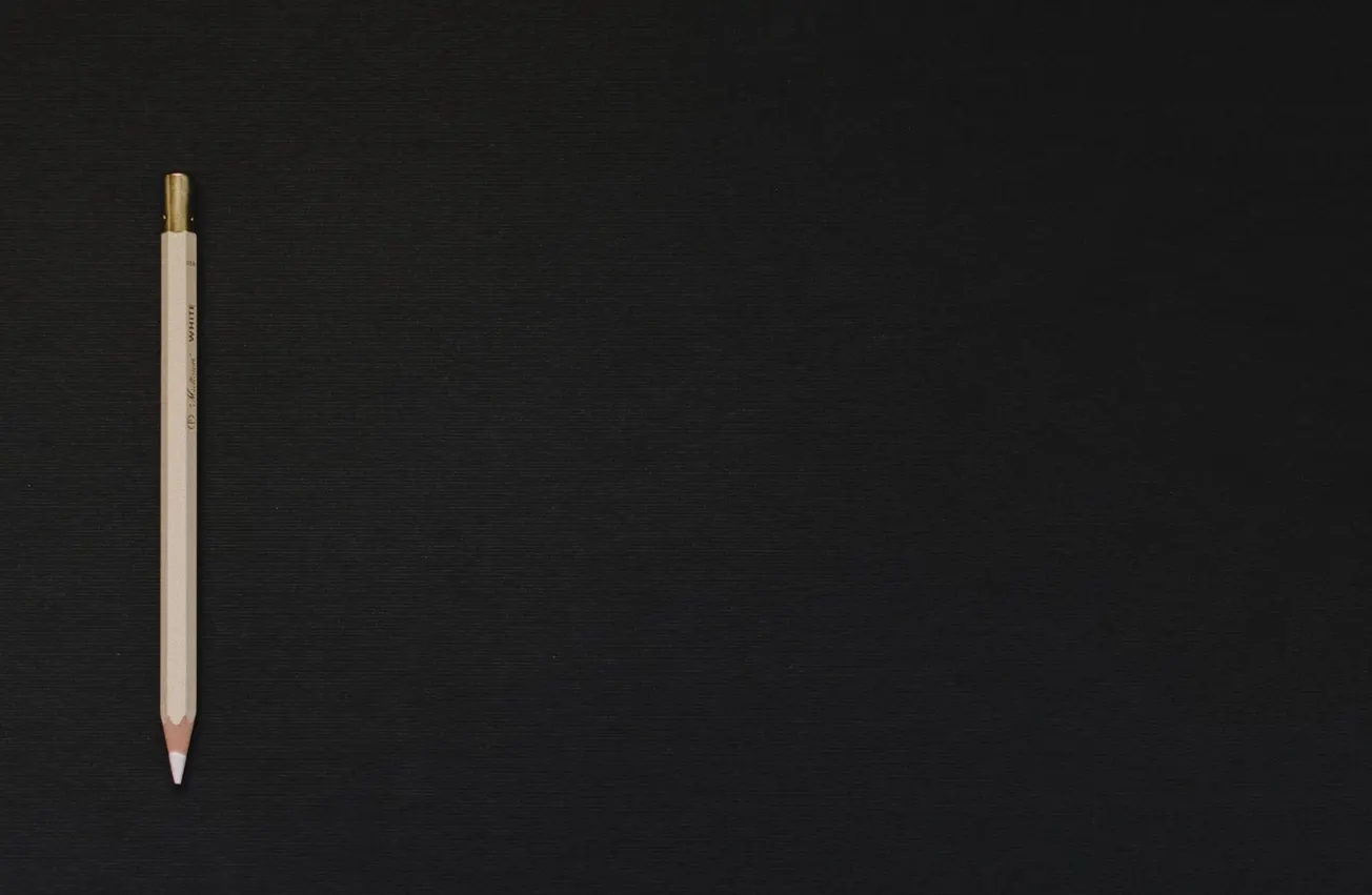 white pencil on black platform