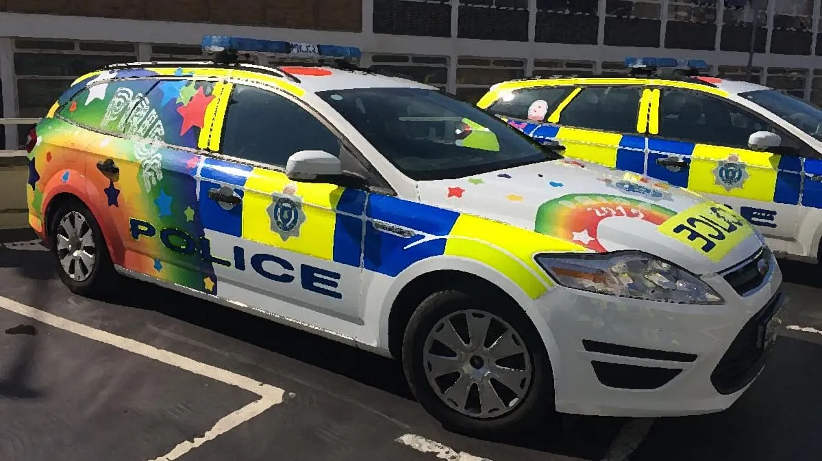 The Sinister Silliness of Rainbow Police Cars