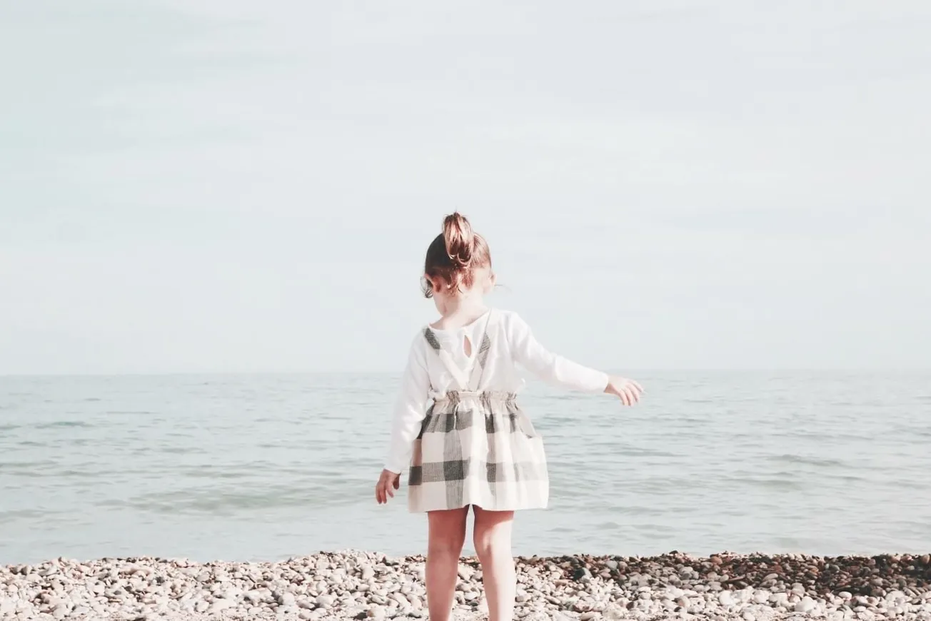 girl walking towards the sea