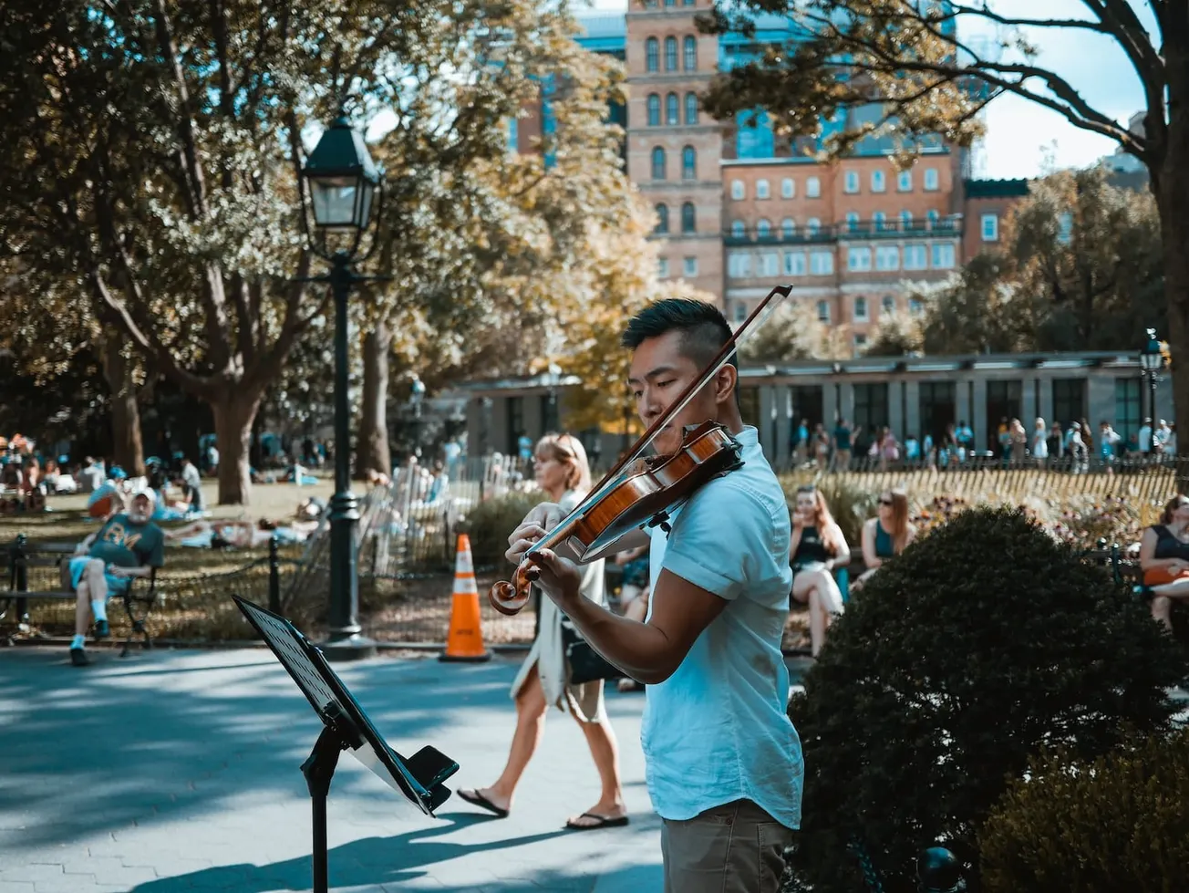 man playing violin at the park