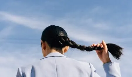 Woman in Light Blue Blazer Holding her Hair