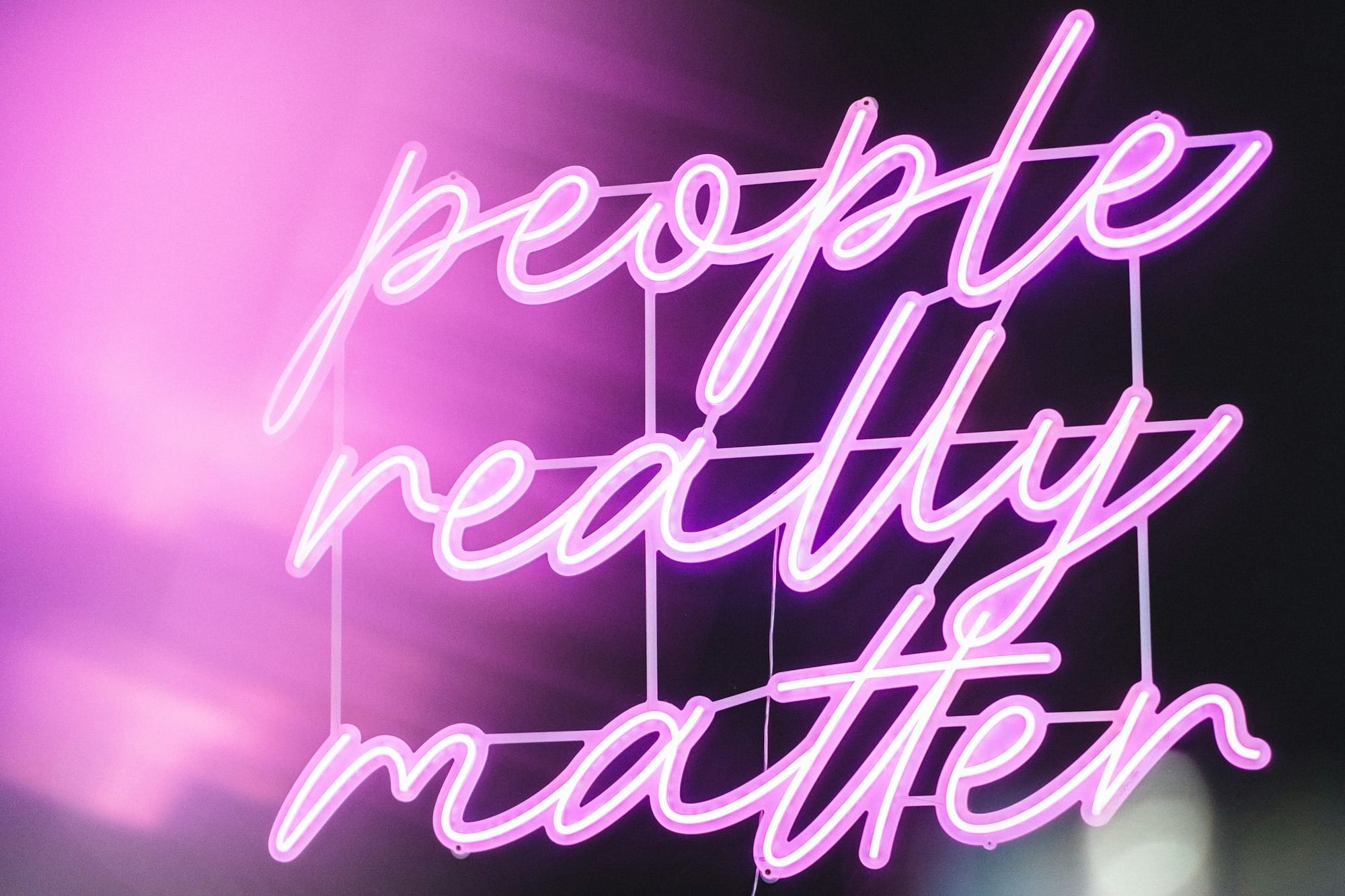 a neon sign that says people really matter