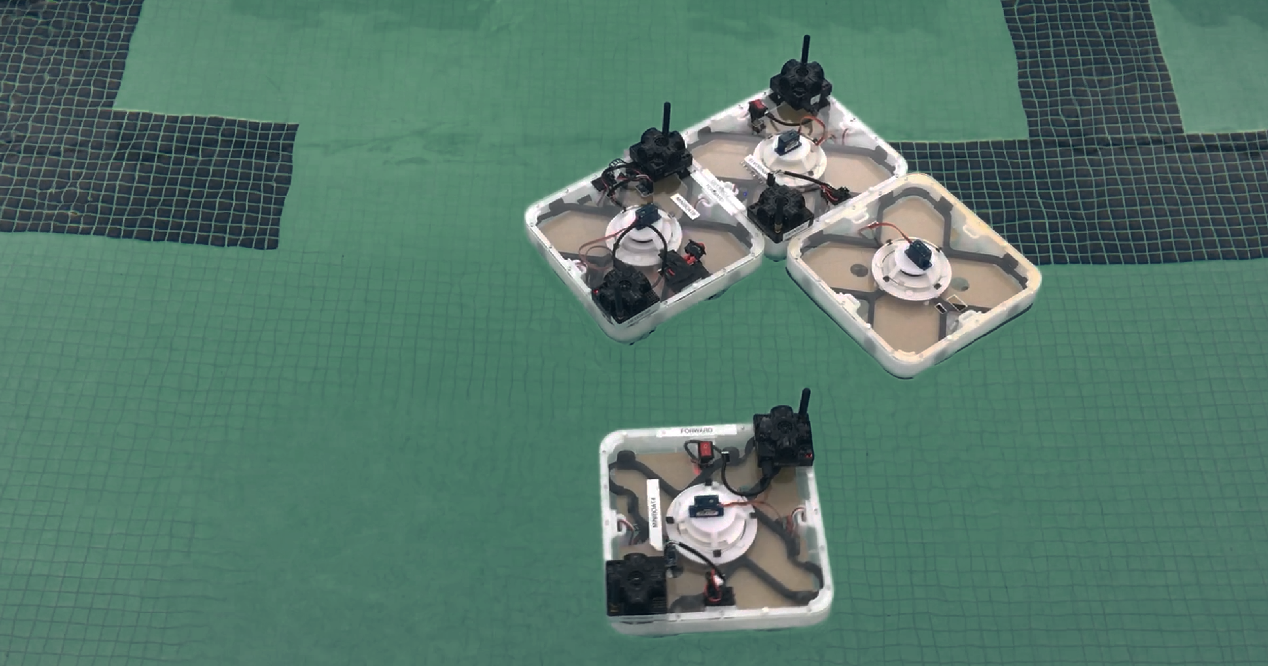 Four squares with wiring in a pool. Three are connected in an L-shape.