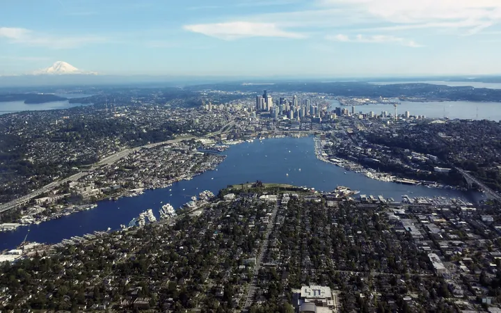 A y-shaped body of water surrounded by a city with skyscrapers at one end.