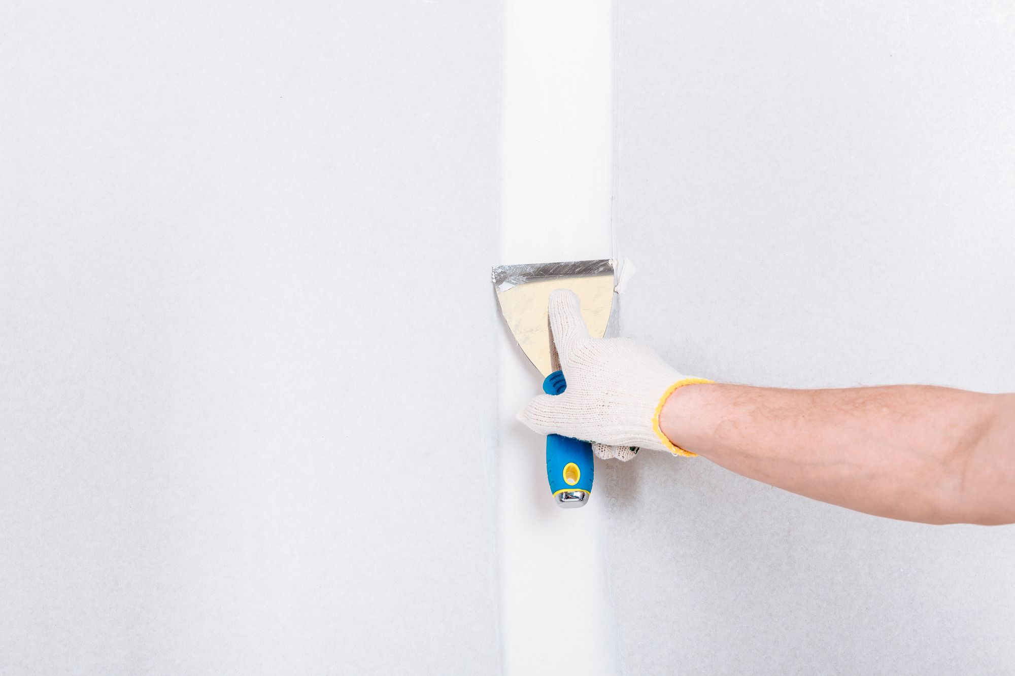 A handyman repairing drywall