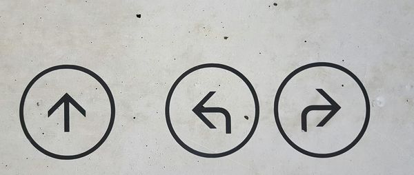 Three arrows on a concrete wall, each pointing a different direction — a visual reminder that when one path isn't working, others are always available.