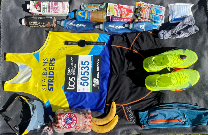 Flat lay photo showing full marathon kit for London 2025, including shoes, nutrition, vest, watch and gear, laid out with precision the night before the race.