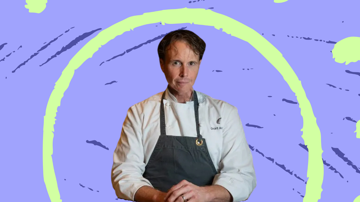 Chef Grant Achatz wearing an apron and white chef's coat.