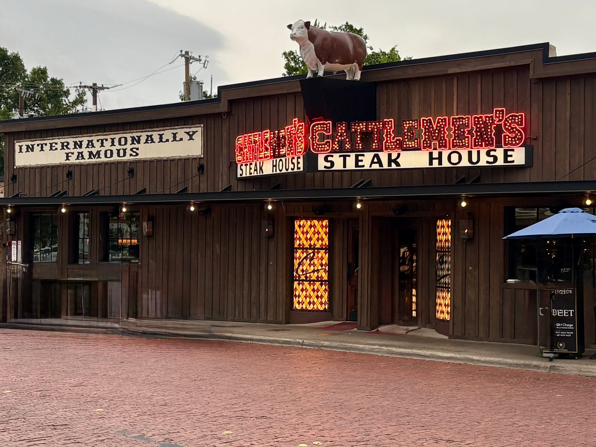 The exterior of a western-themed restaurant with a sign that says Cattlemen's Steak House.